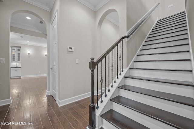 staircase featuring hardwood / wood-style flooring and ornamental molding