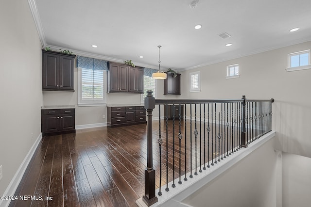 corridor with crown molding and dark wood-type flooring