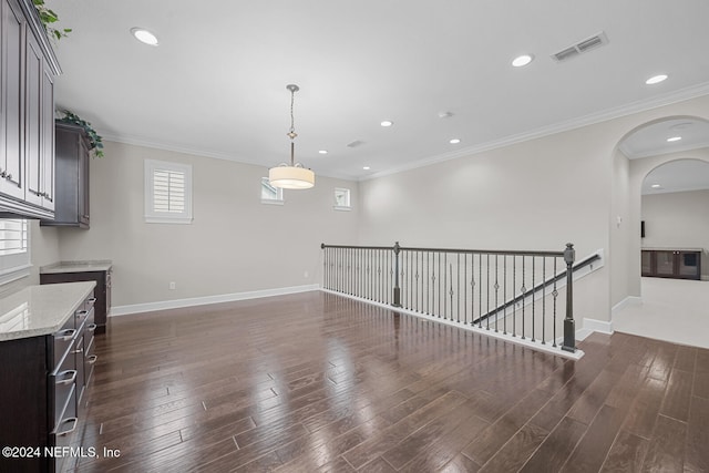 interior space with dark hardwood / wood-style floors and ornamental molding