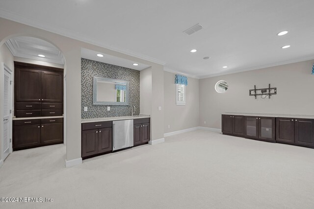 kitchen with light colored carpet and crown molding