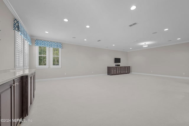 unfurnished living room featuring light colored carpet and ornamental molding