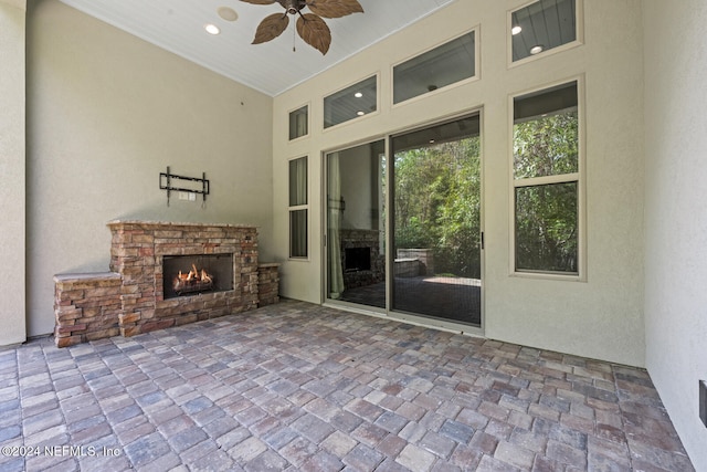 view of patio featuring a fireplace and ceiling fan