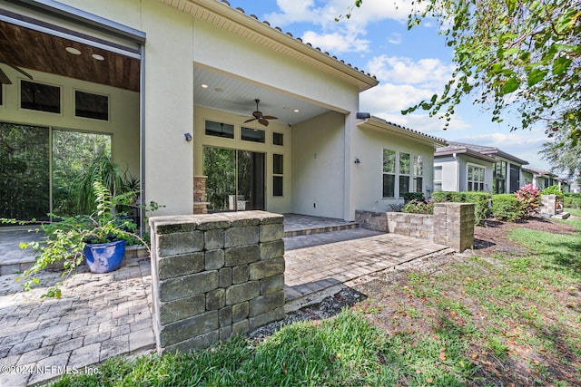 rear view of house with a patio area and ceiling fan