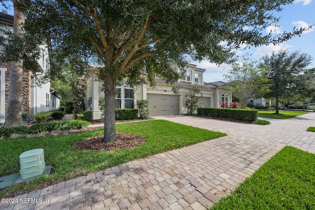 view of front facade with a front yard and a garage