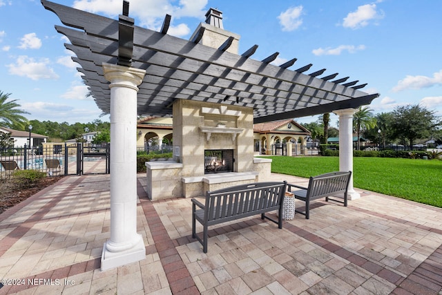 view of patio with a pergola and exterior fireplace