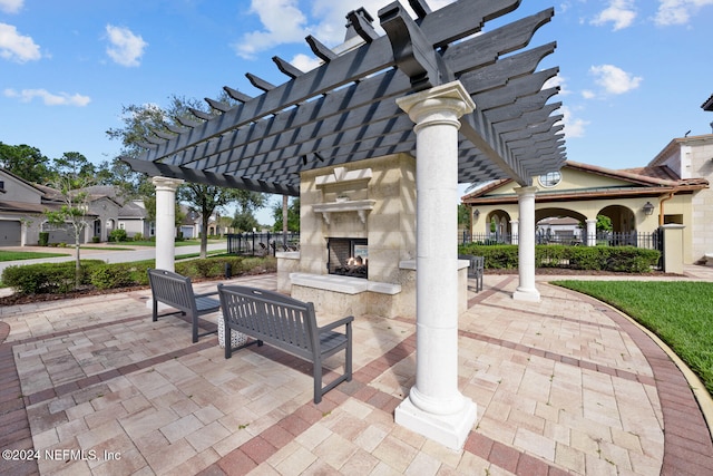 view of patio / terrace with a pergola and exterior fireplace