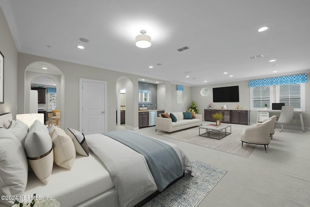 carpeted bedroom with ensuite bathroom, multiple windows, and ornamental molding