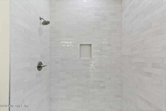 bathroom with tiled shower