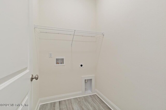 clothes washing area featuring light wood-type flooring, electric dryer hookup, and washer hookup