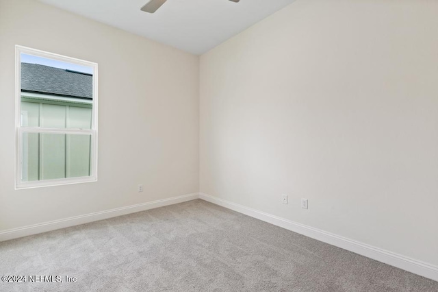 unfurnished room with ceiling fan and light colored carpet