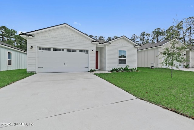 ranch-style home featuring a front yard and a garage