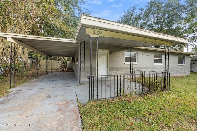 view of side of home with a yard and a carport