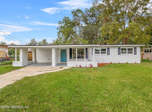 ranch-style house with a carport and a front yard