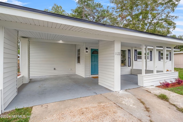 single story home with a porch and a carport