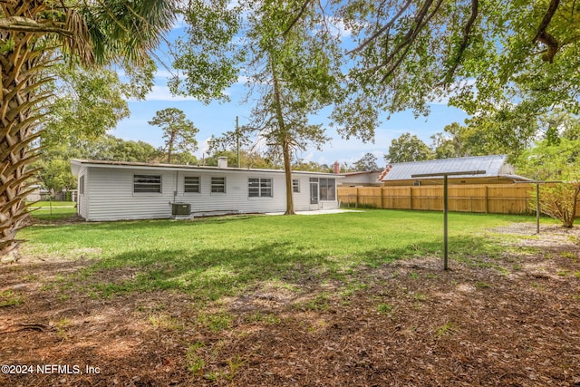 back of house featuring a yard