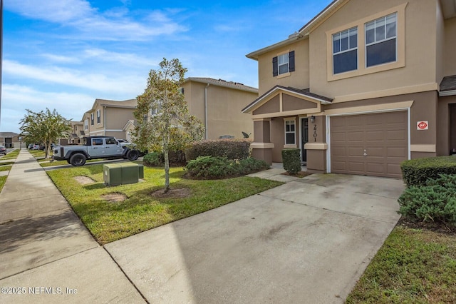 view of front of home featuring a garage and a front yard