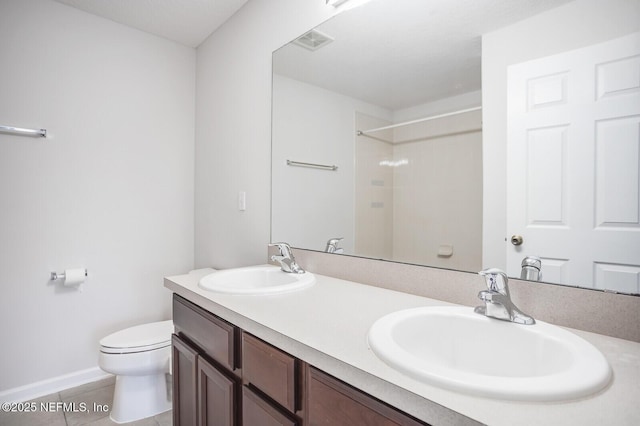 bathroom with vanity, tile patterned floors, and toilet