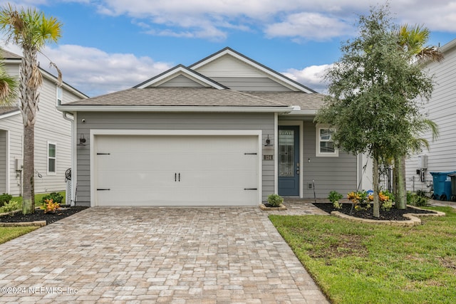 view of front facade with a garage and a front yard