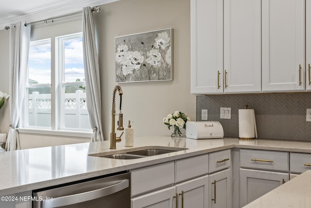 kitchen with light stone countertops, sink, backsplash, and dishwasher