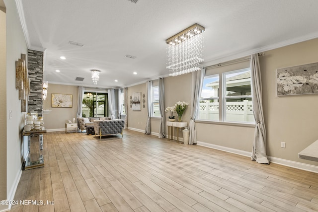 living area featuring light wood-type flooring and ornamental molding