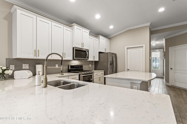 kitchen with white cabinetry, light wood-type flooring, appliances with stainless steel finishes, and crown molding