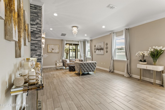 interior space with light wood-type flooring, crown molding, and plenty of natural light