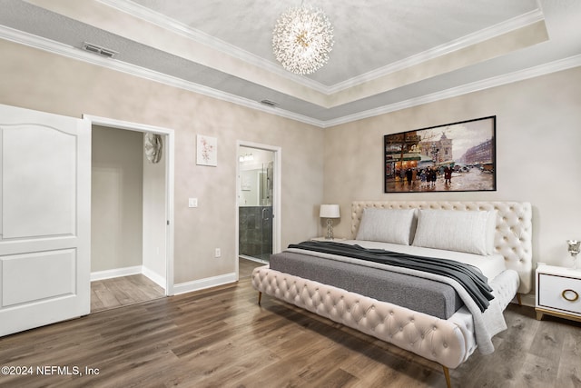 bedroom featuring wood-type flooring, a notable chandelier, ornamental molding, and ensuite bathroom