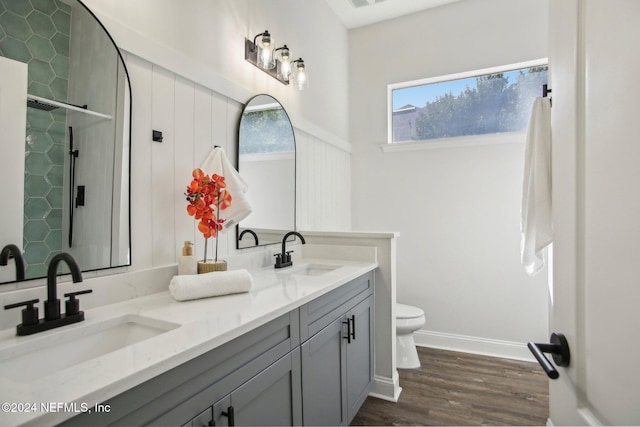 bathroom featuring walk in shower, wood-type flooring, toilet, and vanity