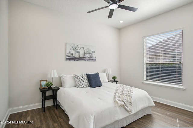 bedroom featuring ceiling fan and dark hardwood / wood-style floors