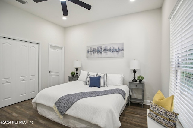 bedroom with dark hardwood / wood-style flooring, ceiling fan, and a closet