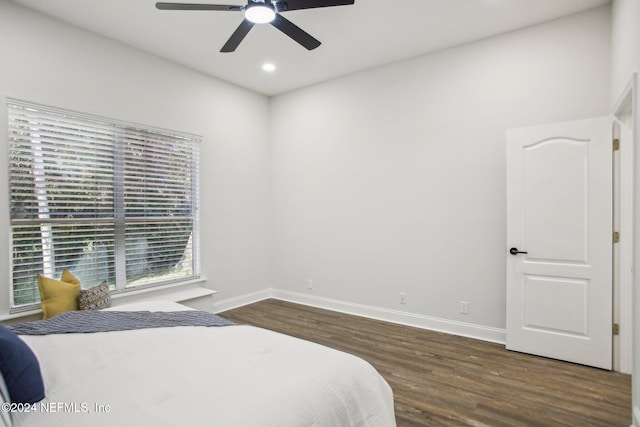 bedroom with dark wood-type flooring and ceiling fan