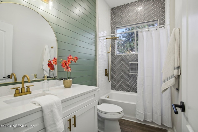 full bathroom featuring vanity, hardwood / wood-style flooring, toilet, and shower / bathtub combination with curtain