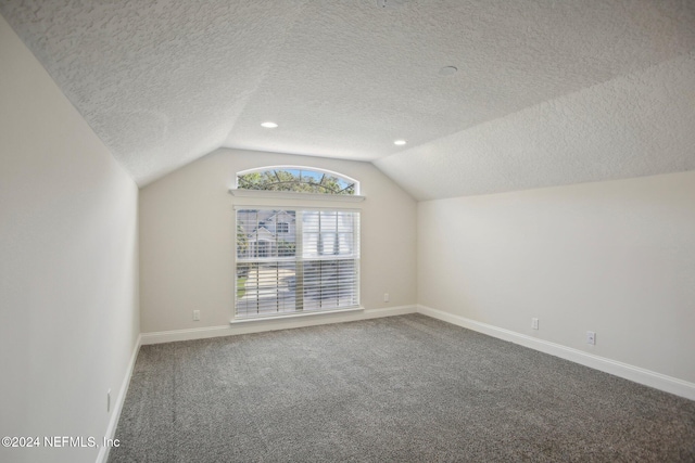 bonus room featuring carpet floors, a textured ceiling, and vaulted ceiling