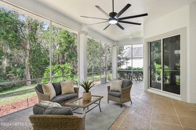 sunroom featuring ceiling fan