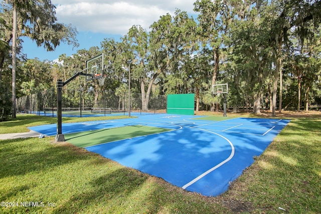 view of basketball court with a lawn