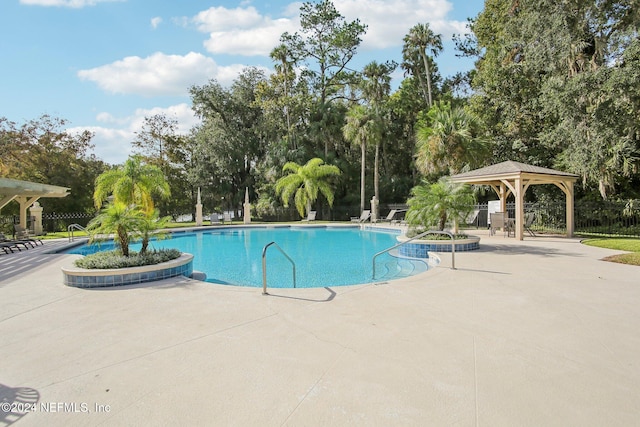 view of swimming pool with a patio and a gazebo