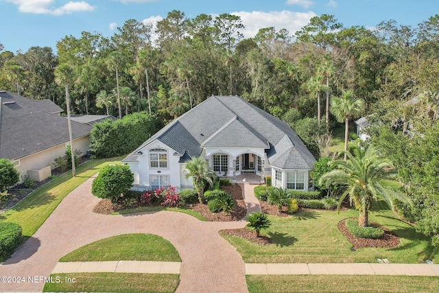 french country style house featuring a front yard