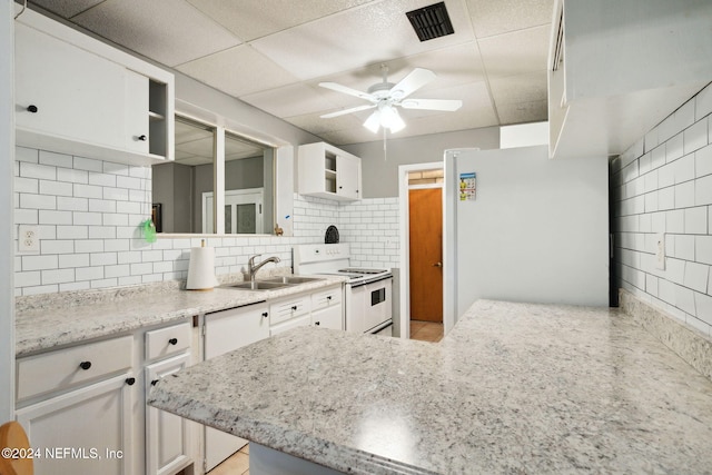 kitchen featuring white cabinetry, white appliances, sink, and backsplash