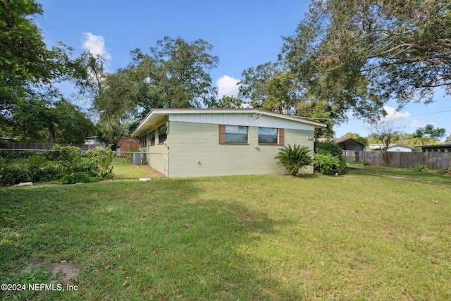 view of home's exterior with a lawn