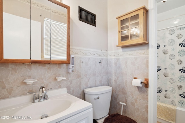 full bathroom featuring tile walls, vanity, shower / bath combo, and toilet