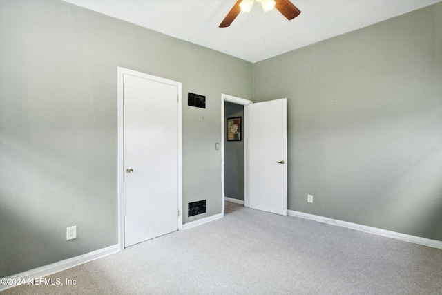 unfurnished bedroom featuring ceiling fan and light colored carpet