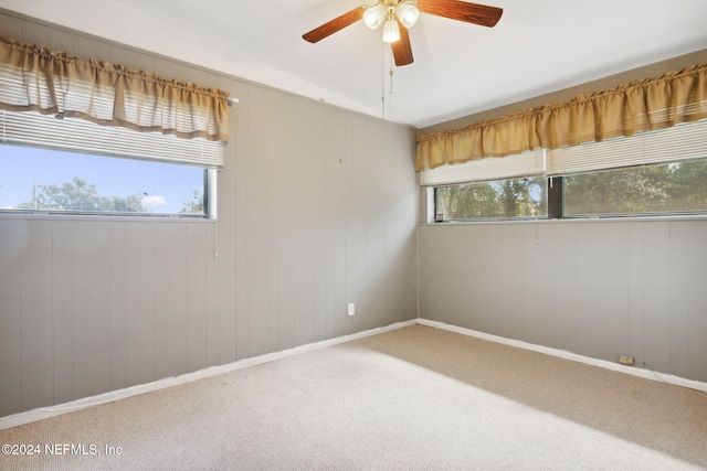 unfurnished room featuring carpet, a wealth of natural light, and ceiling fan