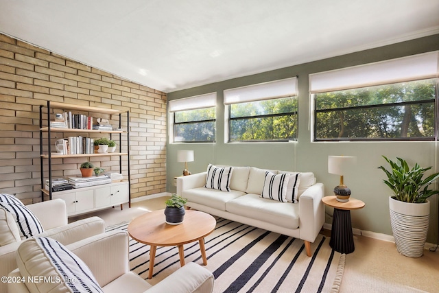 living room with light carpet and brick wall