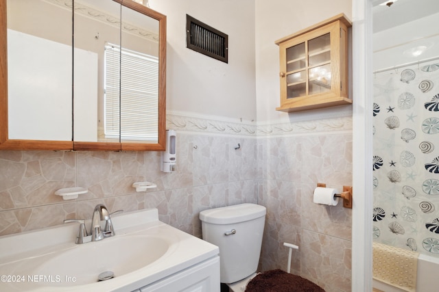 full bathroom featuring toilet, vanity, tile walls, and shower / bathtub combination with curtain