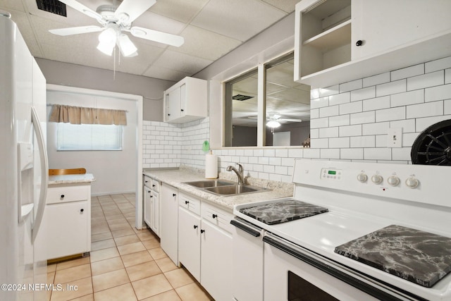 kitchen featuring backsplash, white appliances, sink, and white cabinets