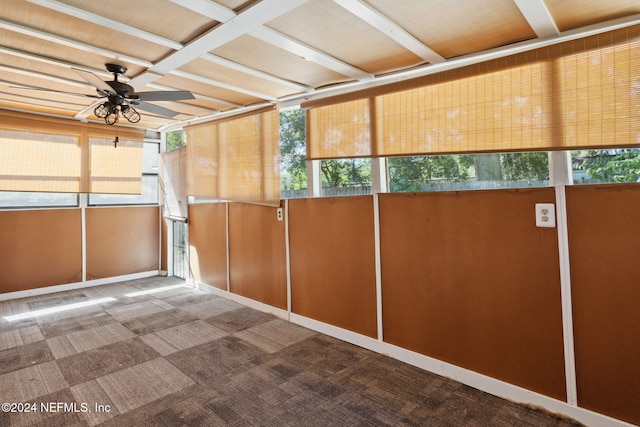 unfurnished sunroom with ceiling fan and a healthy amount of sunlight