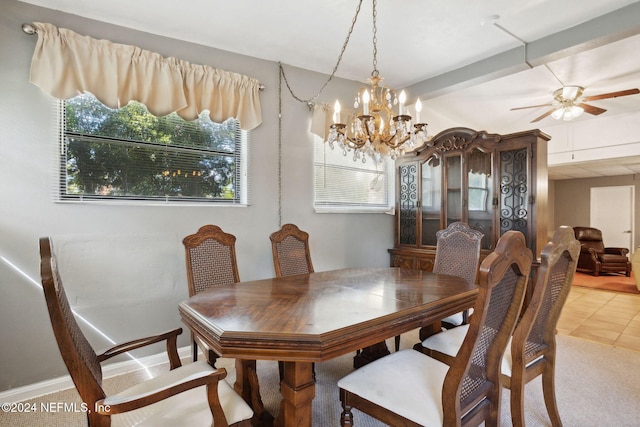 dining room with ceiling fan with notable chandelier and tile patterned floors