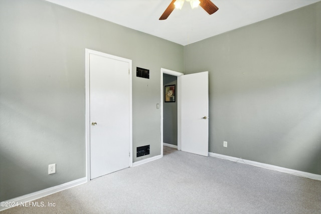 unfurnished bedroom featuring light colored carpet and ceiling fan