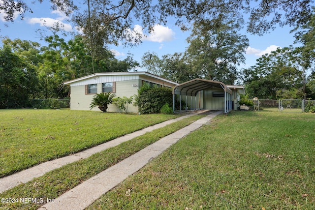 view of front facade featuring a carport and a front yard