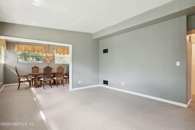 dining room featuring a chandelier and carpet flooring